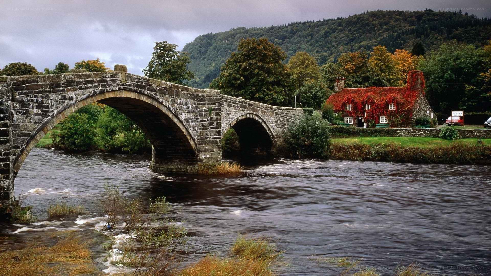Stone bridge over river with cottage
