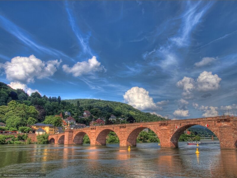 Stone bridge over river with town