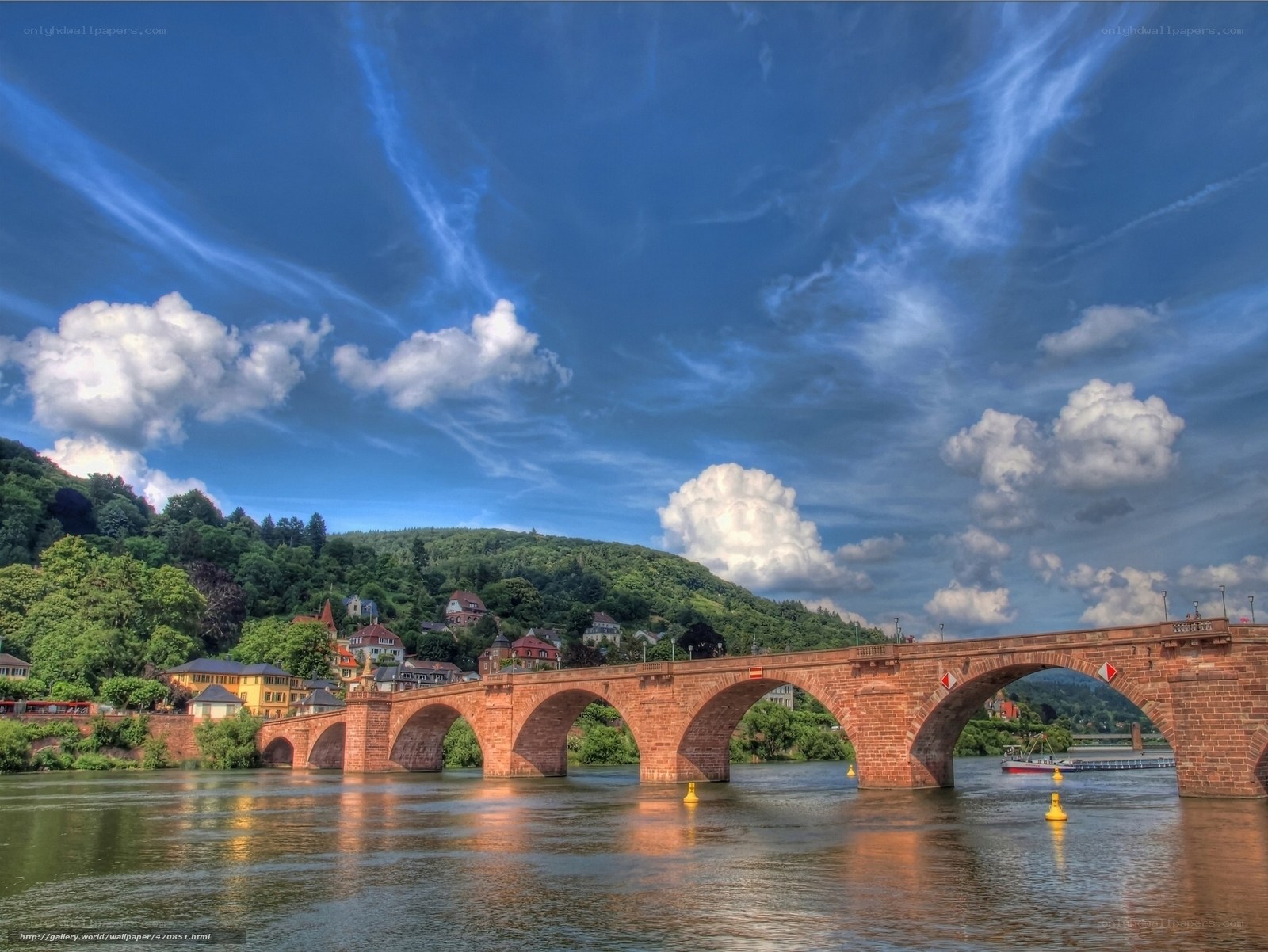 Stone bridge over river with town