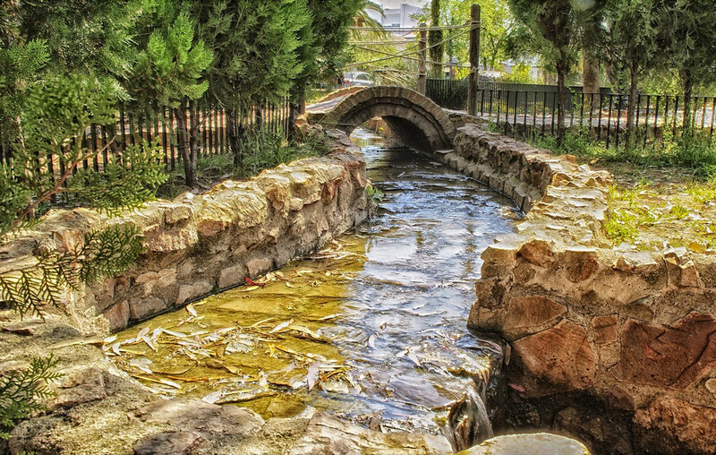 Stone Bridge over Stream — Green, Serene, Afternoon, Photograph, Trees, Fence