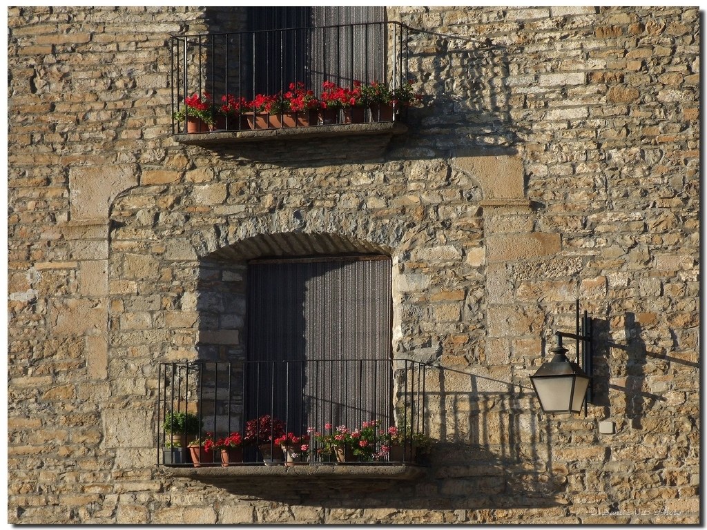 Stone building with flower balconies