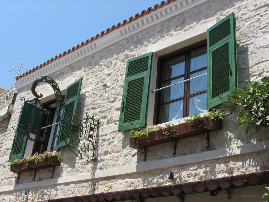 Stone building with green shutters
