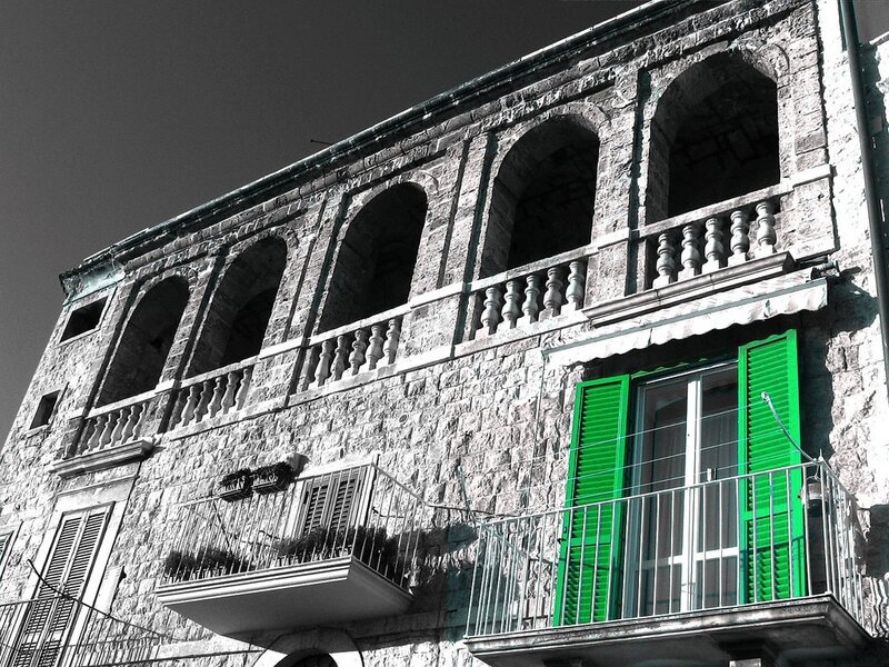 stone building with green shutters