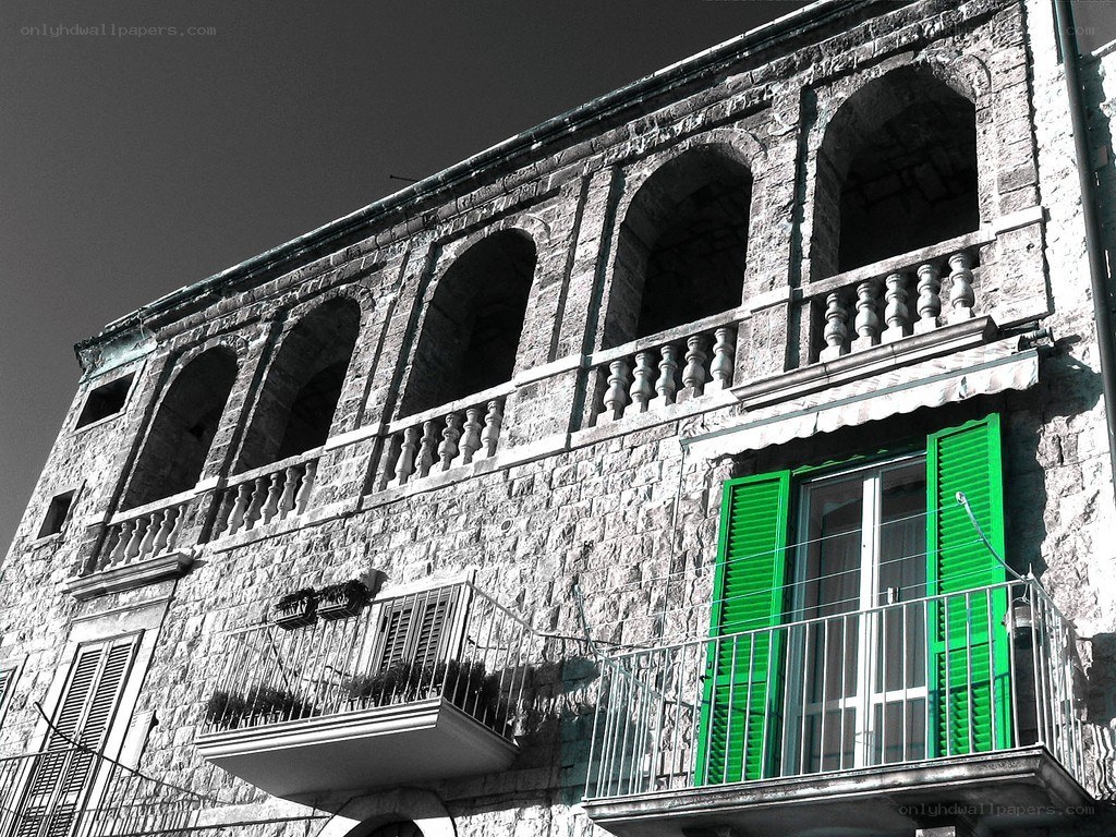 stone building with green shutters