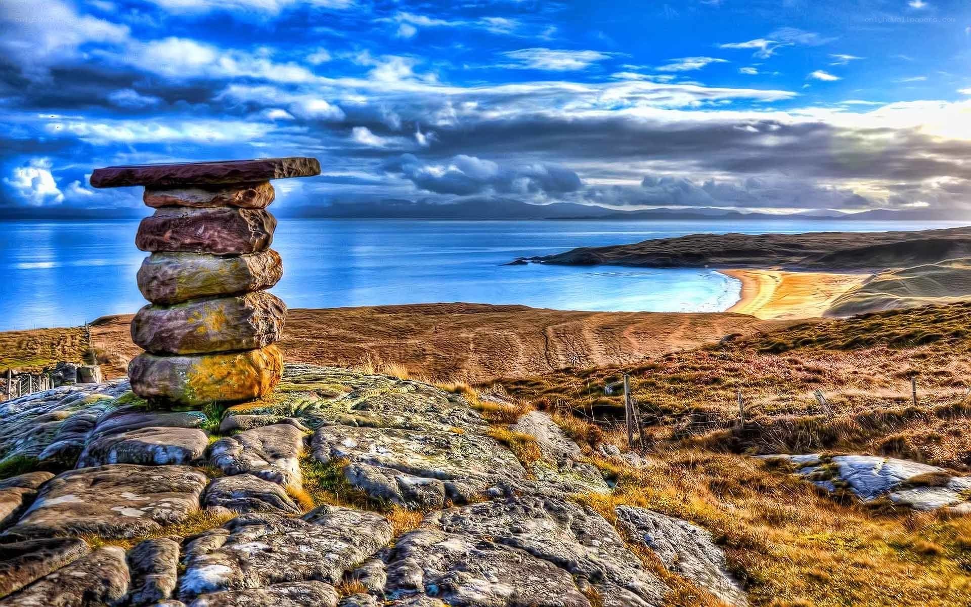 Stone cairn overlooking a coastal bay