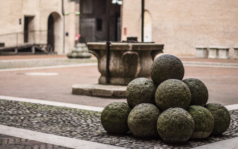 Stone cannonballs in a courtyard
