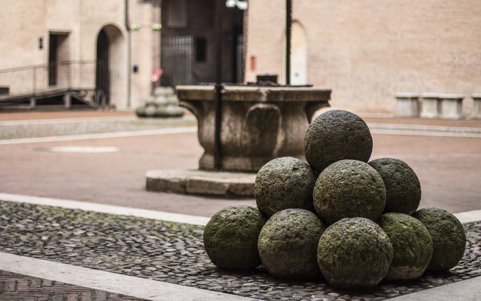 Stone cannonballs in a courtyard