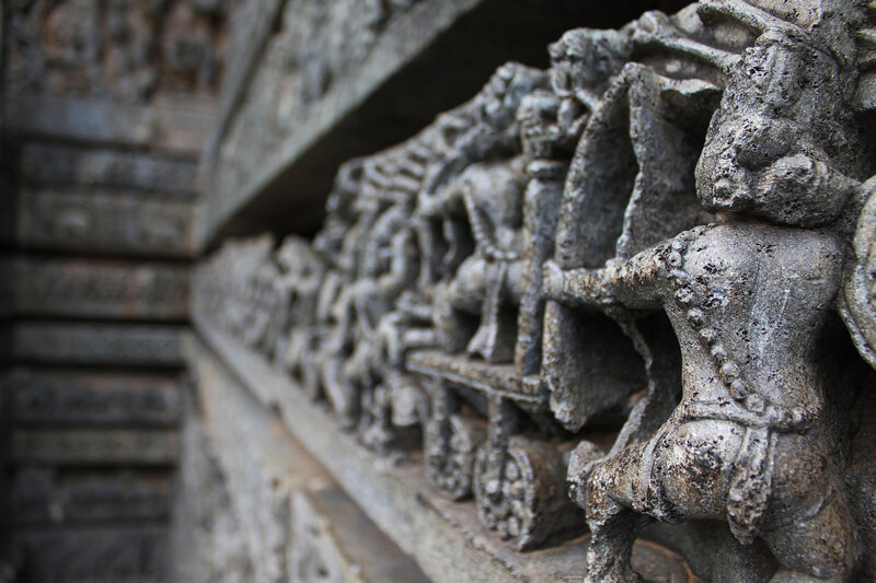 stone carving of chariot scene