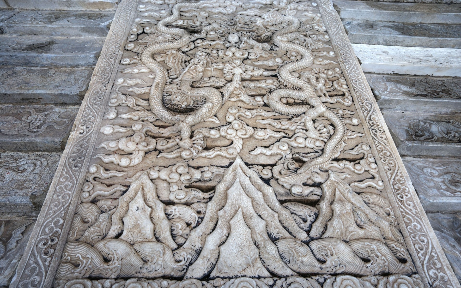 Stone carving of dragons and mountains