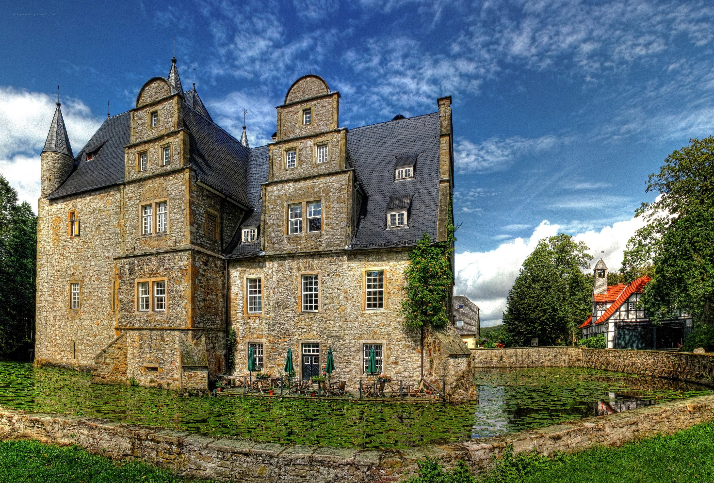 Stone castle with moat and pond