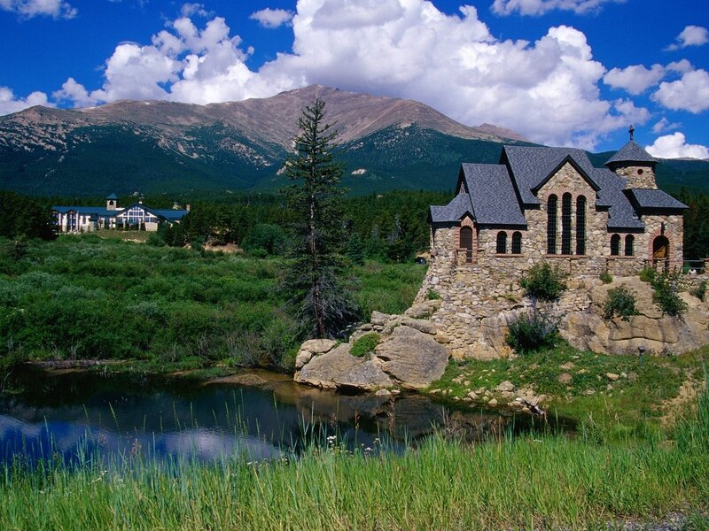 Stone chapel by a mountain lake
