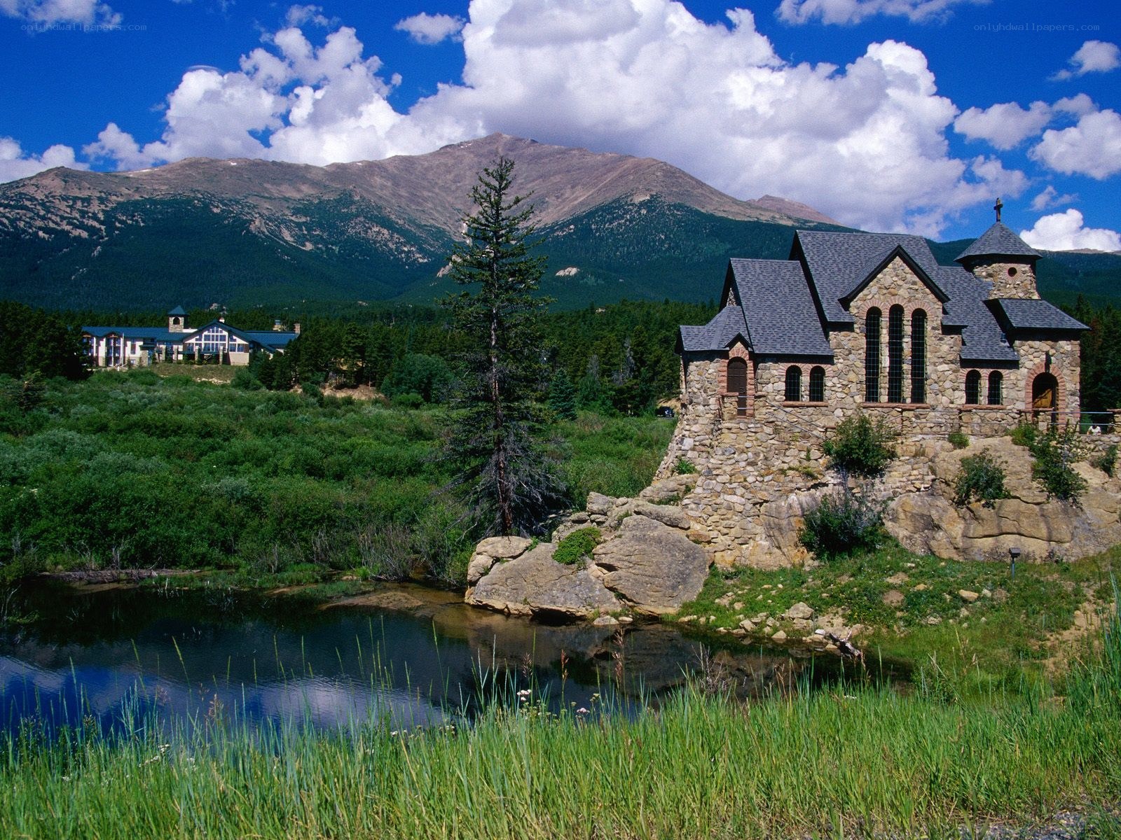 Stone chapel by a mountain lake