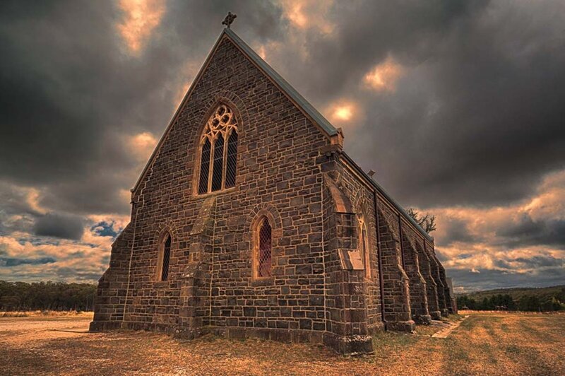 Stone church under stormy sky