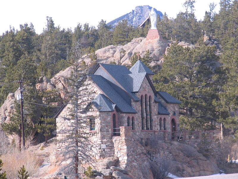 Stone church with statue on hill