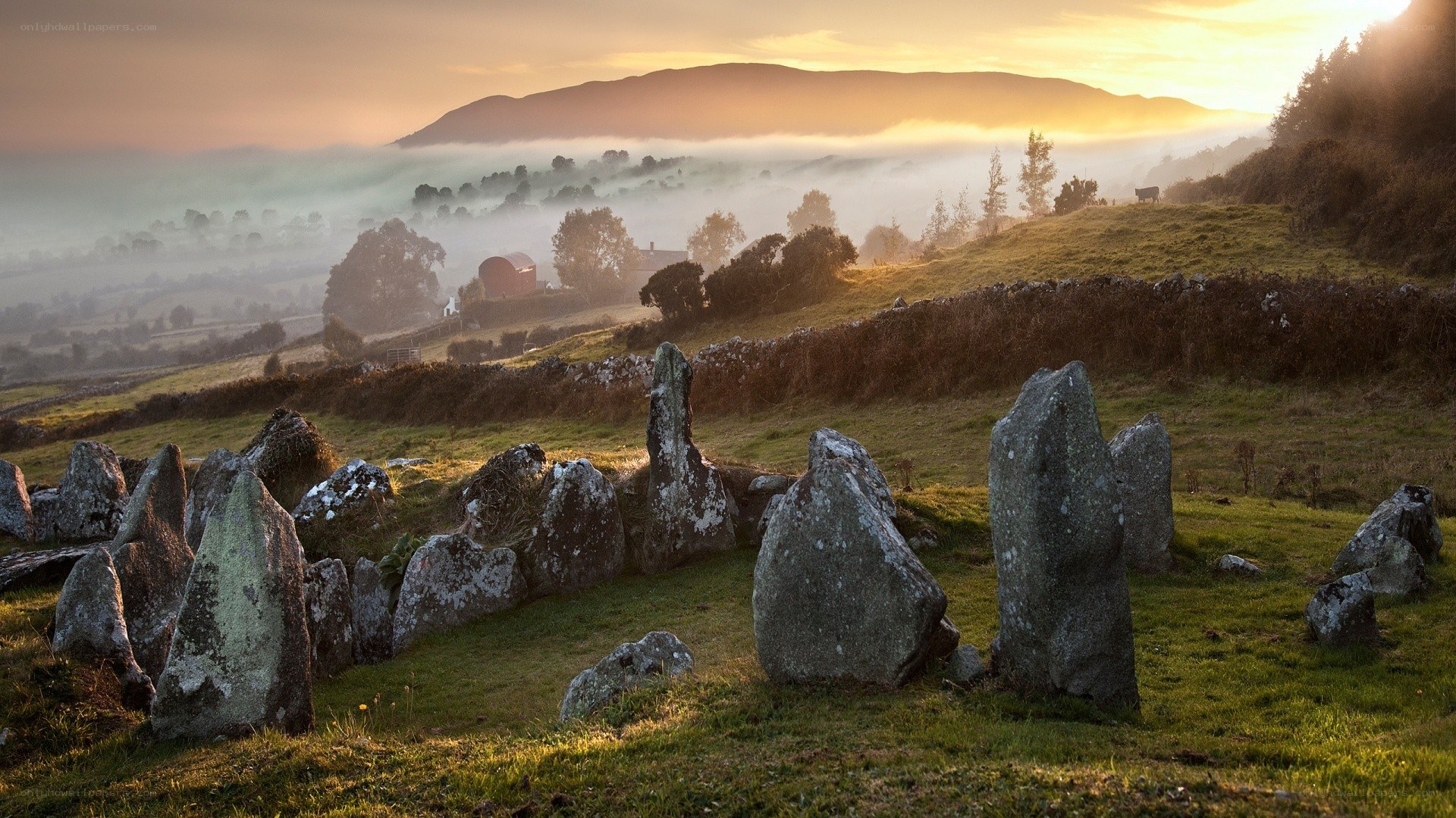 Stone circle at sunrise in mist