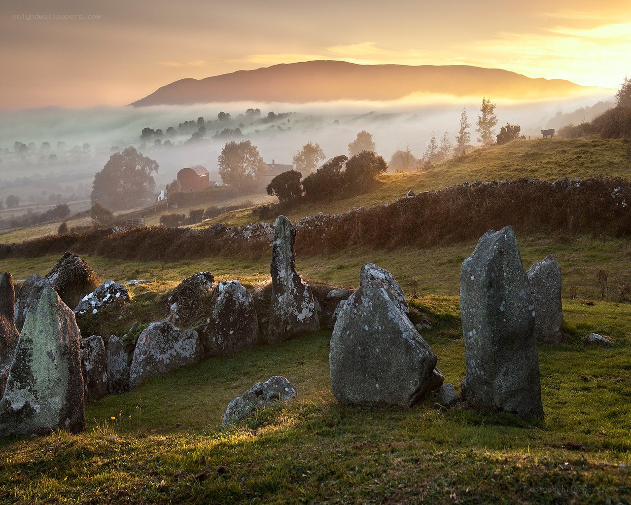 Stone circle at sunrise in mist
