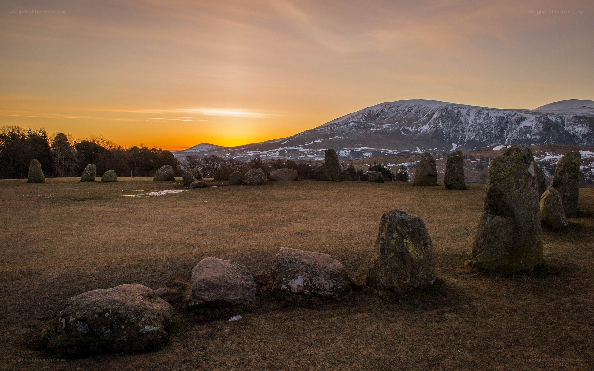 Stone circle at sunset with mountain