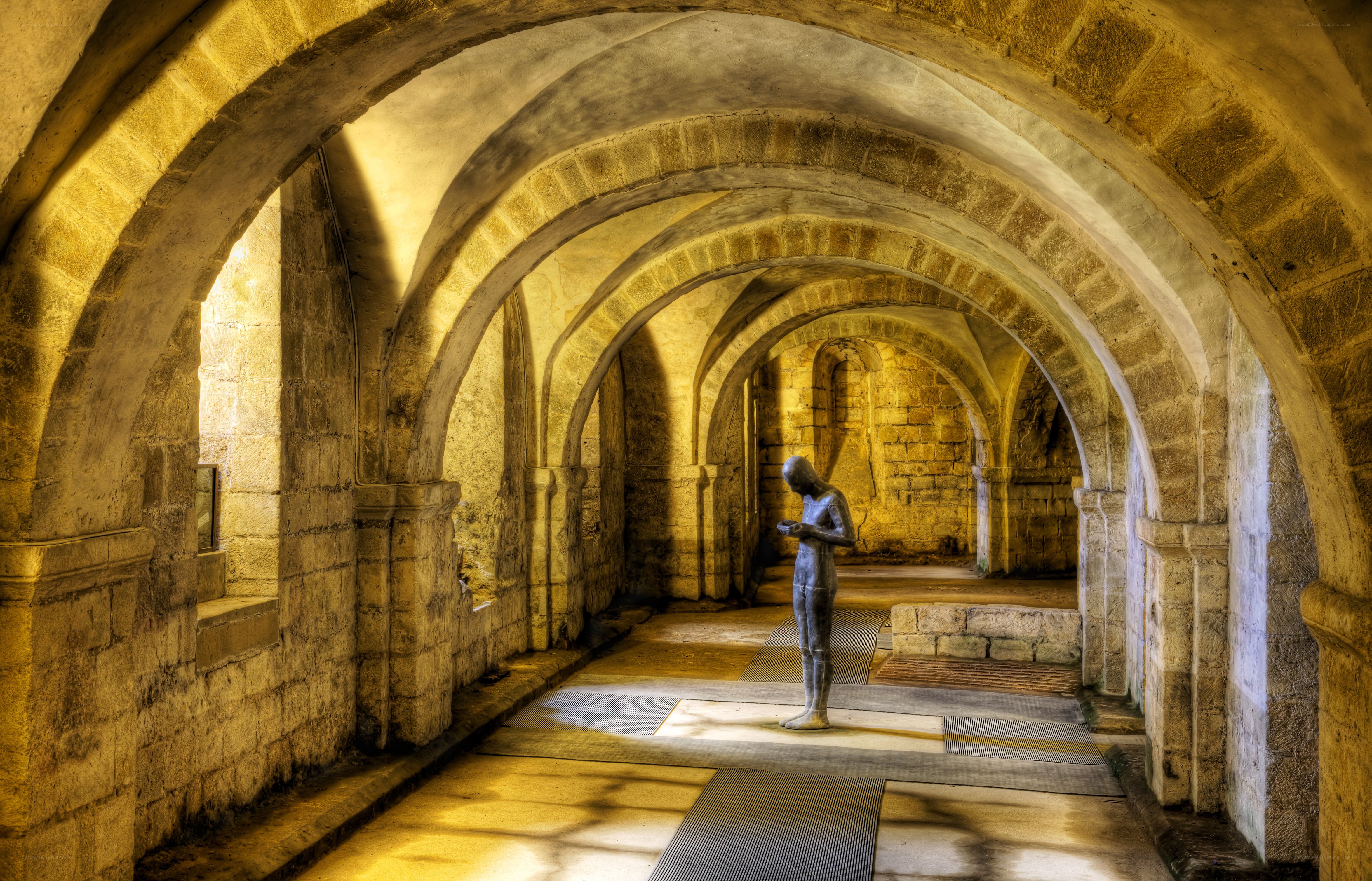 Stone corridor with statue