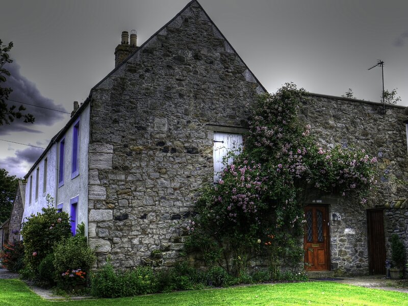 Stone cottage with flowering vines
