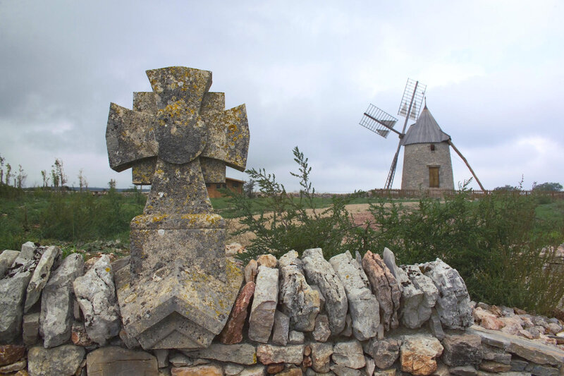 Stone cross and windmill landscape