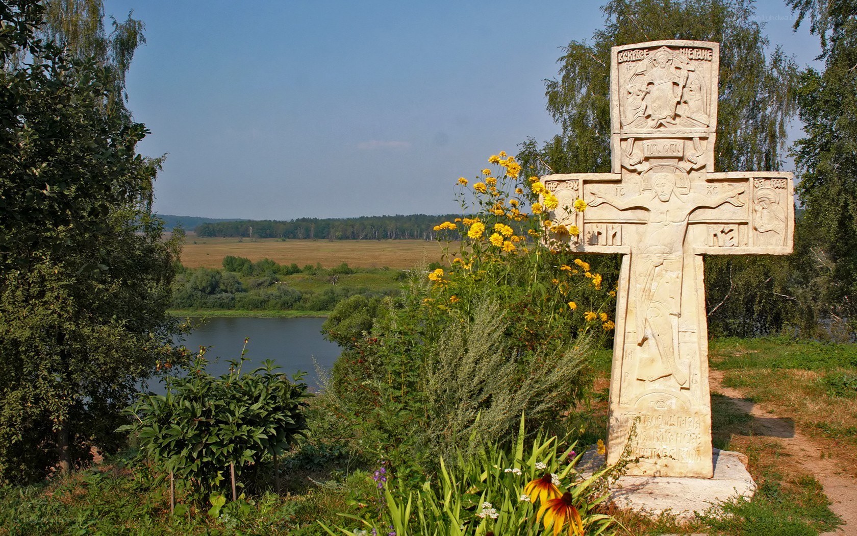 Stone cross by a river