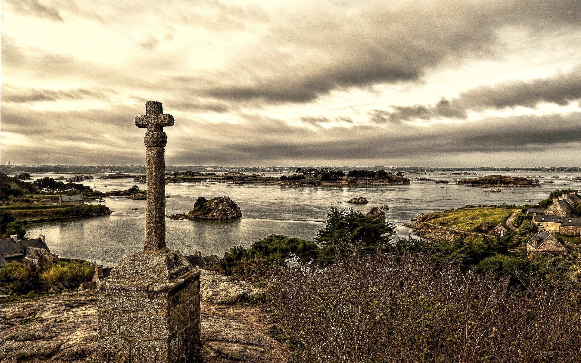 Stone cross overlooking a coastal inlet