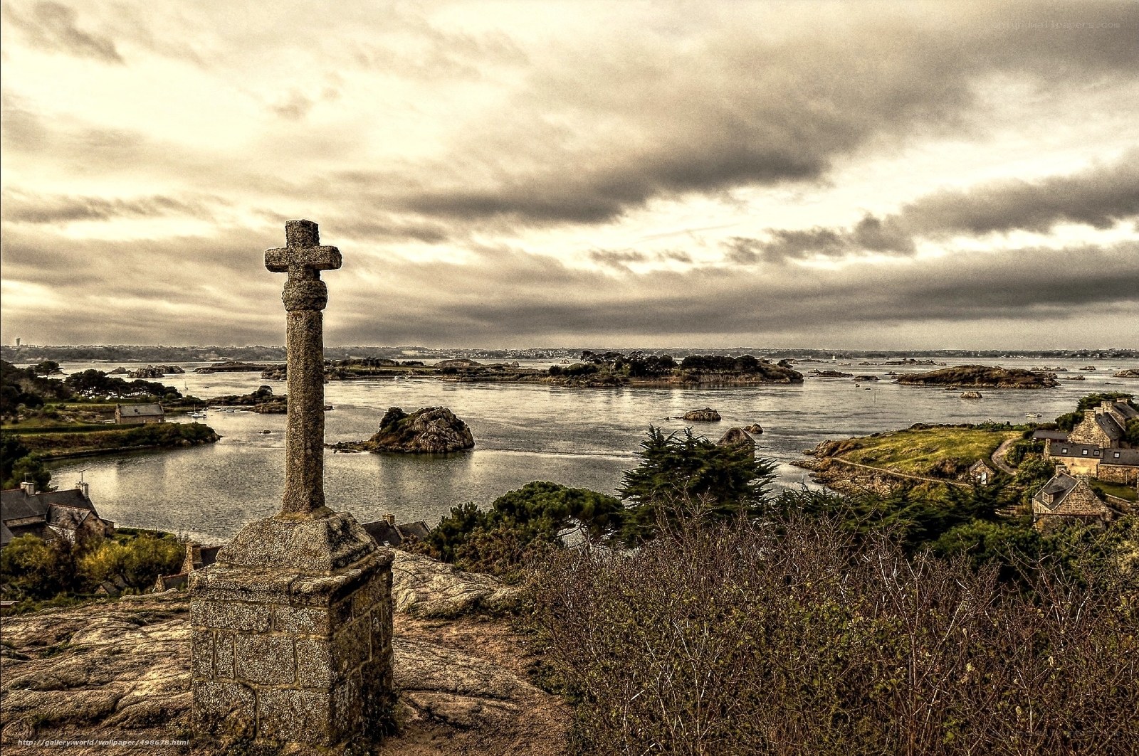Stone cross overlooking a coastal inlet