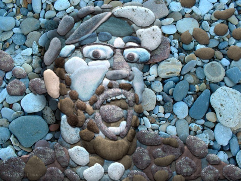 stone face art on beach