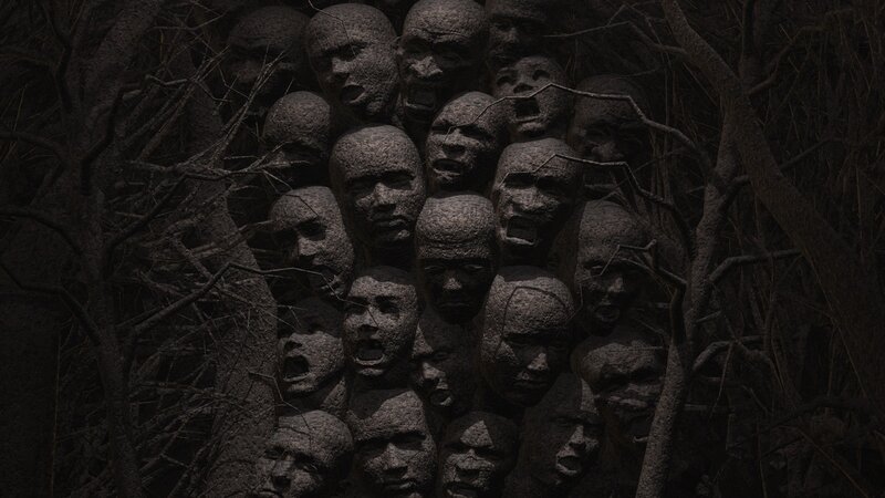 stone faces in dark forest