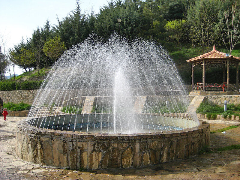 Stone Fountain Spraying Water — Green