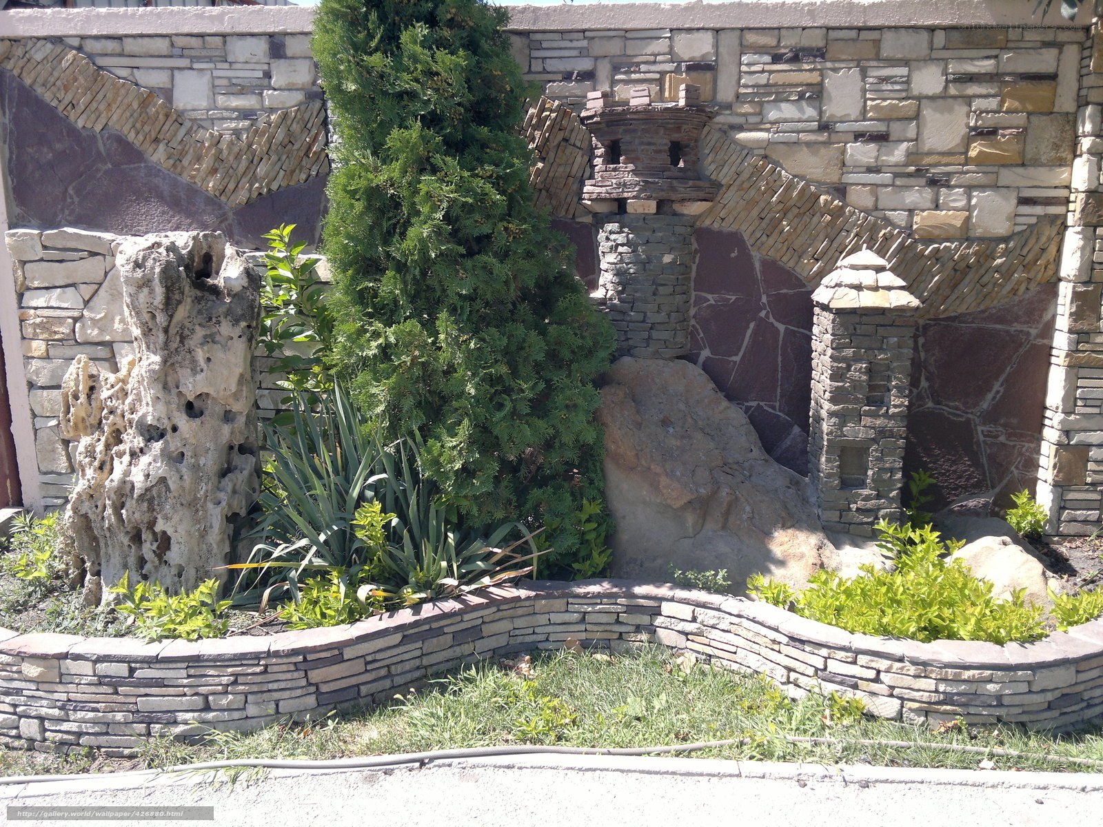 Stone garden wall with greenery