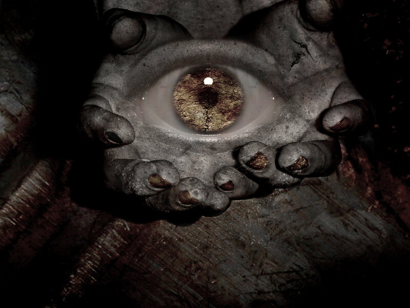 stone hand holding an eye