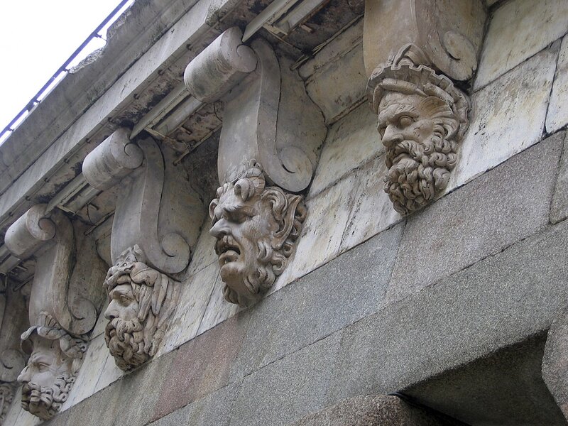 stone heads on building facade