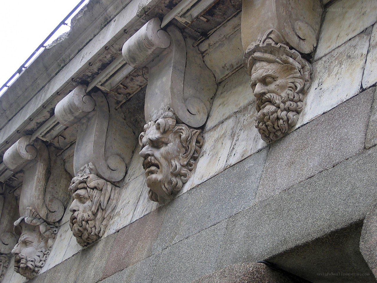 stone heads on building facade