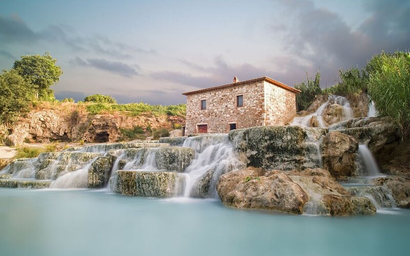 Stone house by waterfall