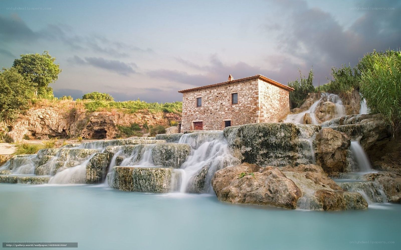 Stone house by waterfall