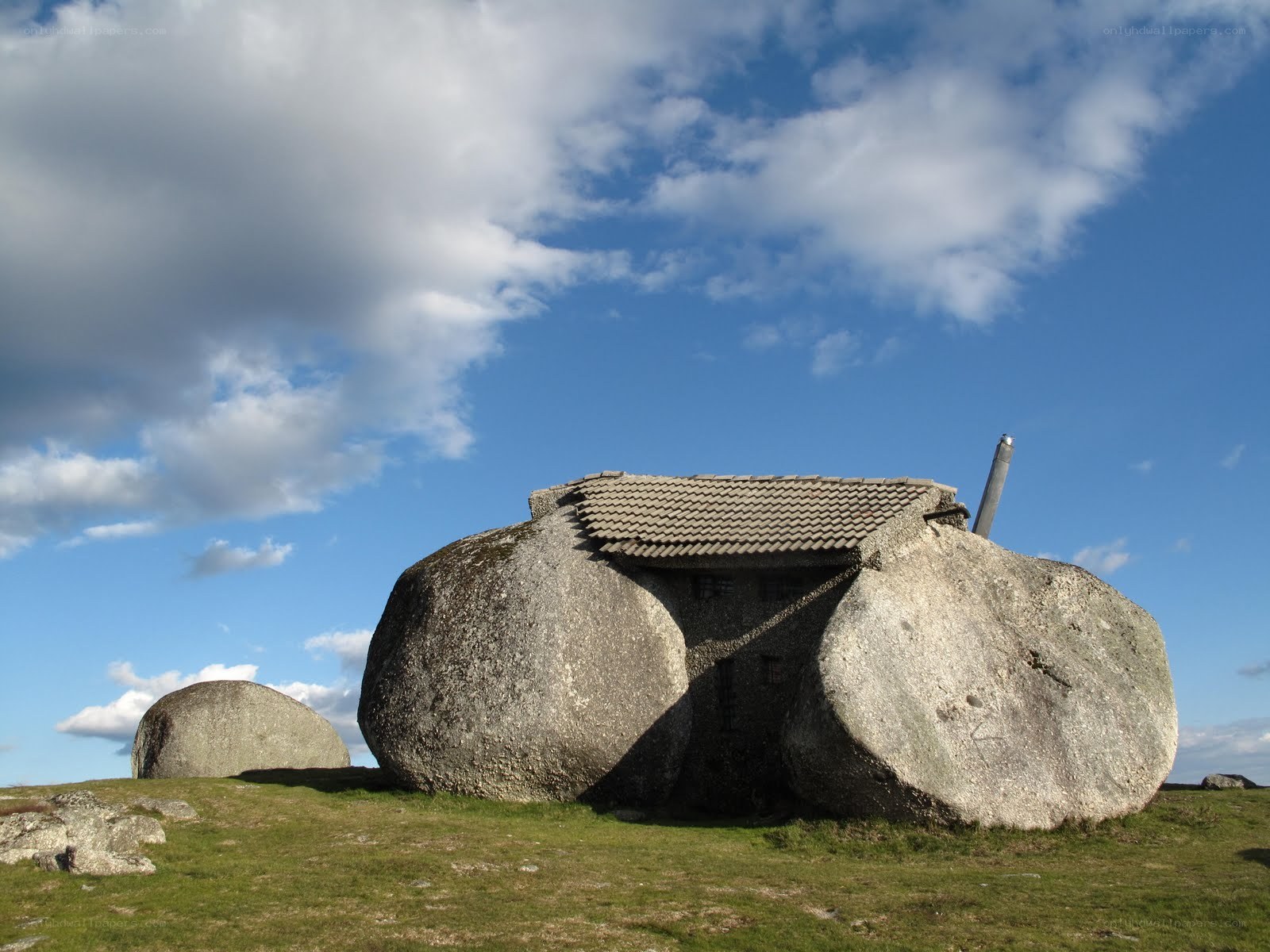 Stone house on a grassy hill