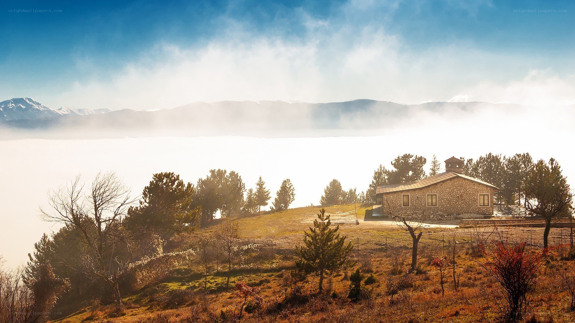 Stone house on a misty hill