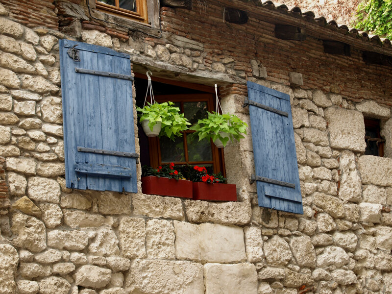 Stone house with blue shutters