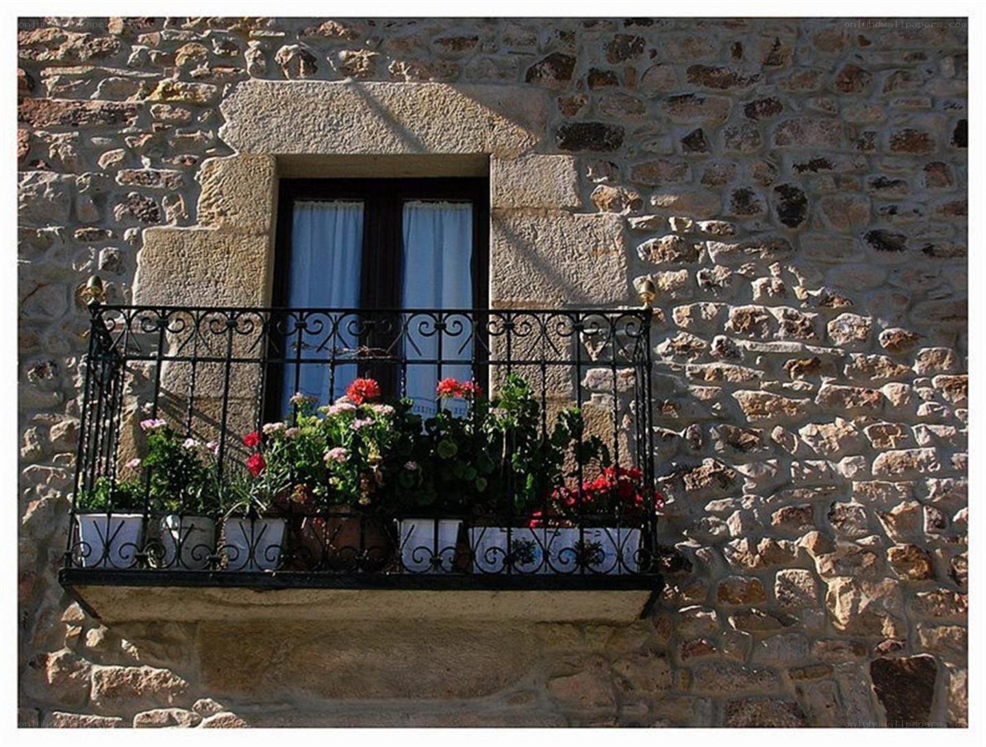 Stone house with flower balcony