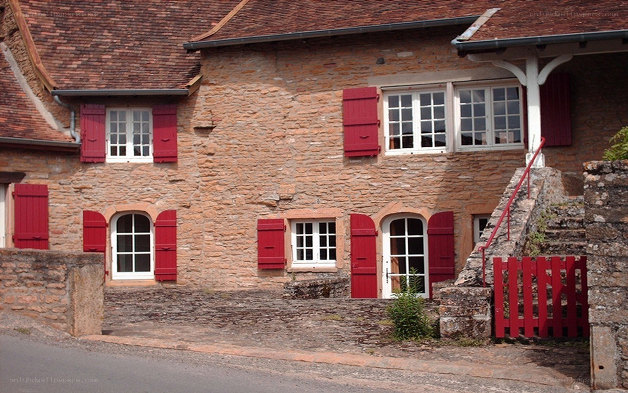 Stone house with red shutters