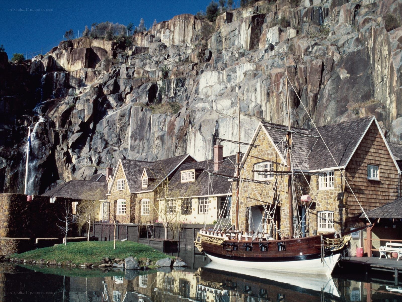 Stone houses by a ship dock