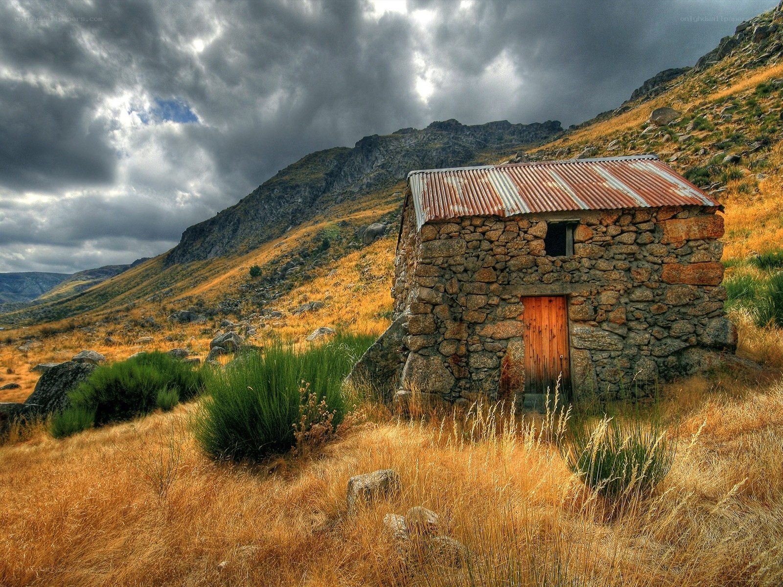 Stone hut in mountain valley