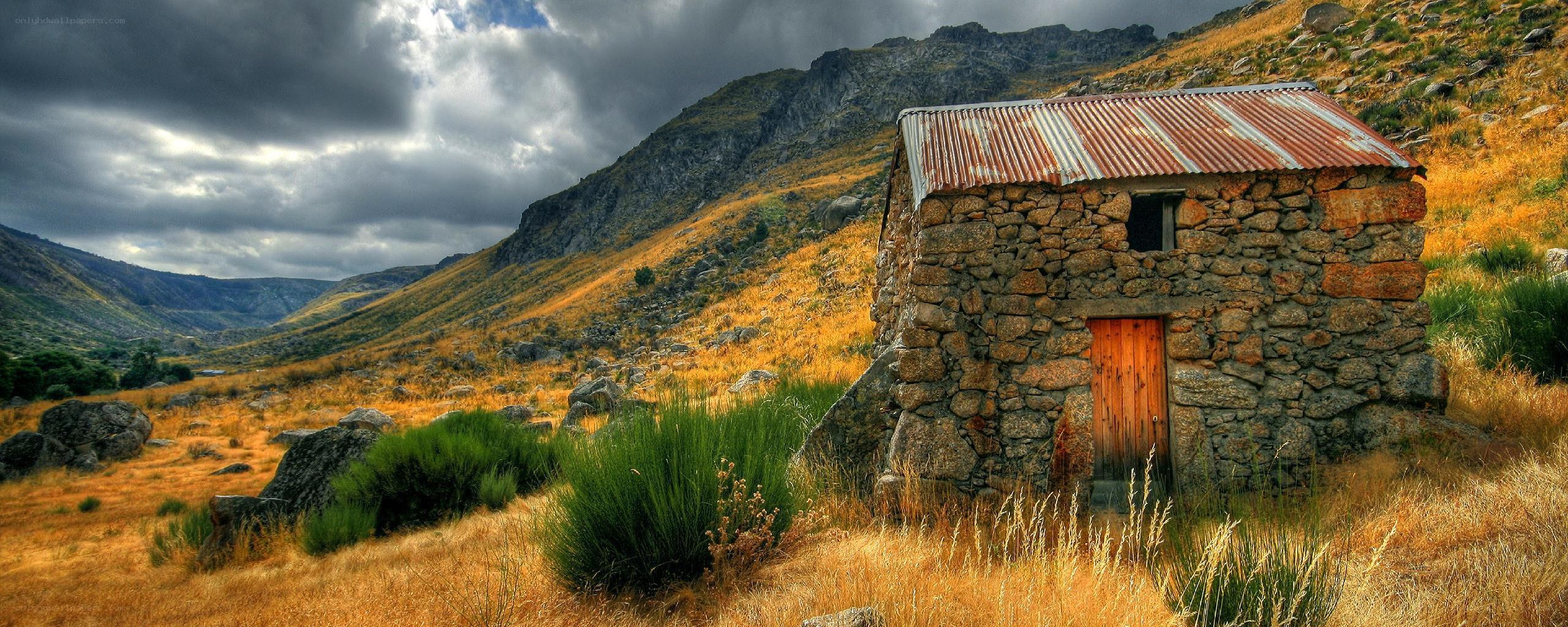 Stone hut in mountain valley