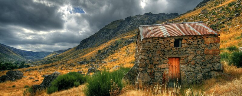Stone hut in mountain valley