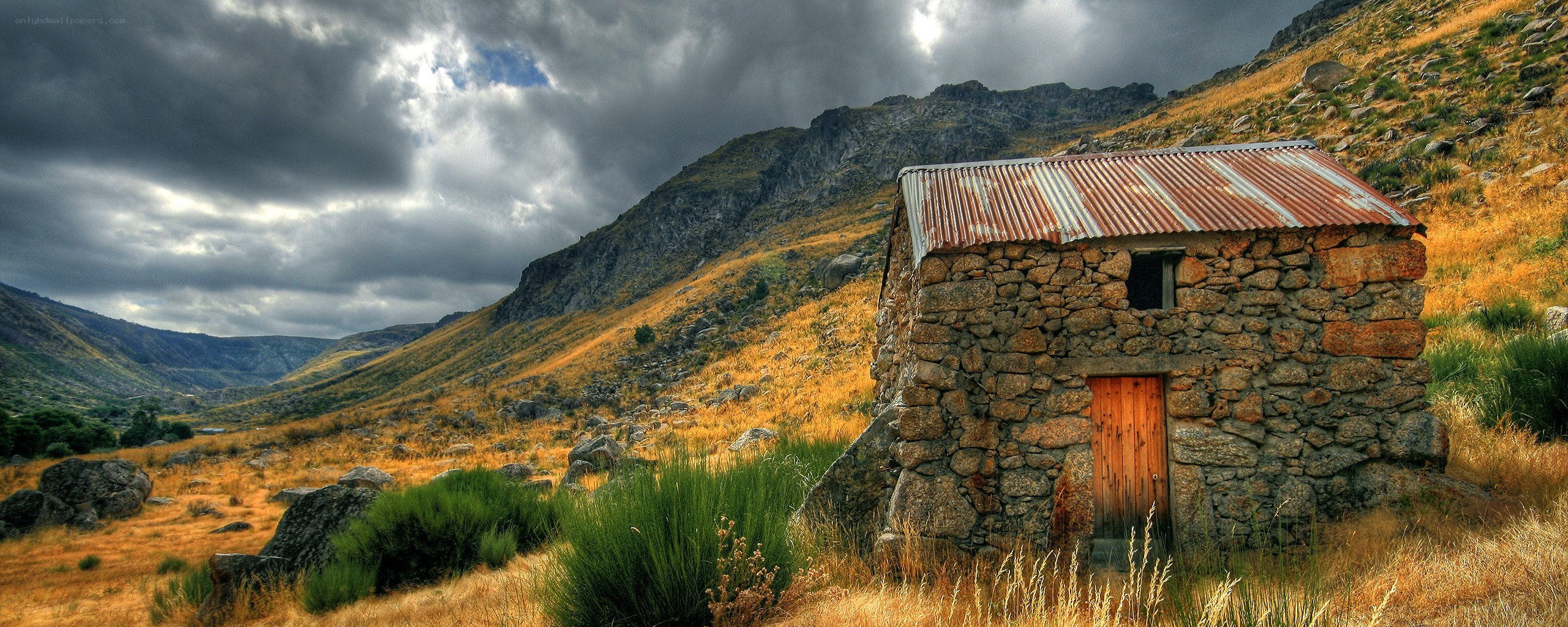 Stone hut in mountain valley
