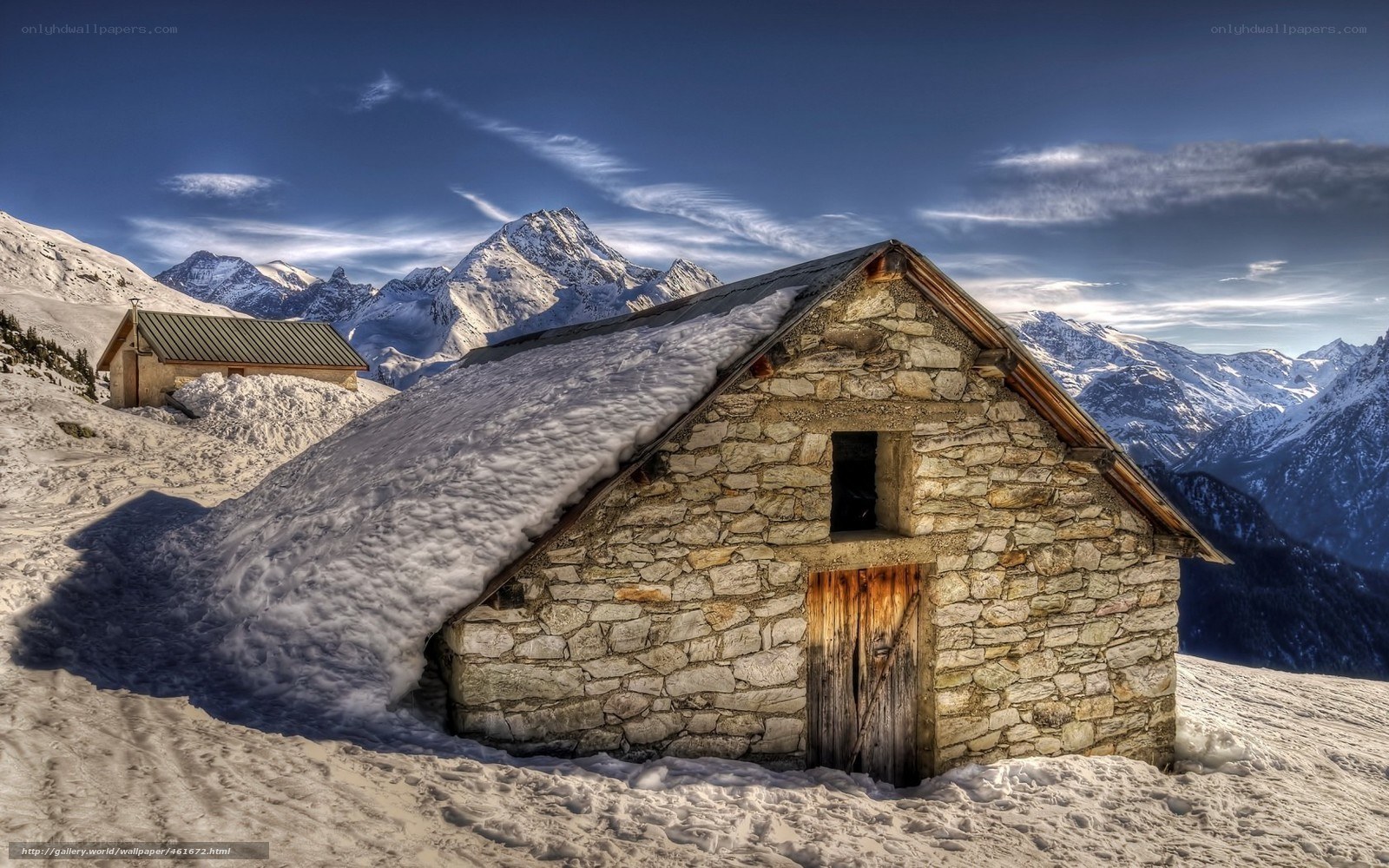 Stone hut in snowy mountains