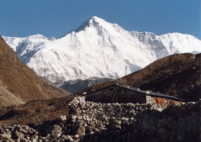 Stone hut near snow-capped mountain