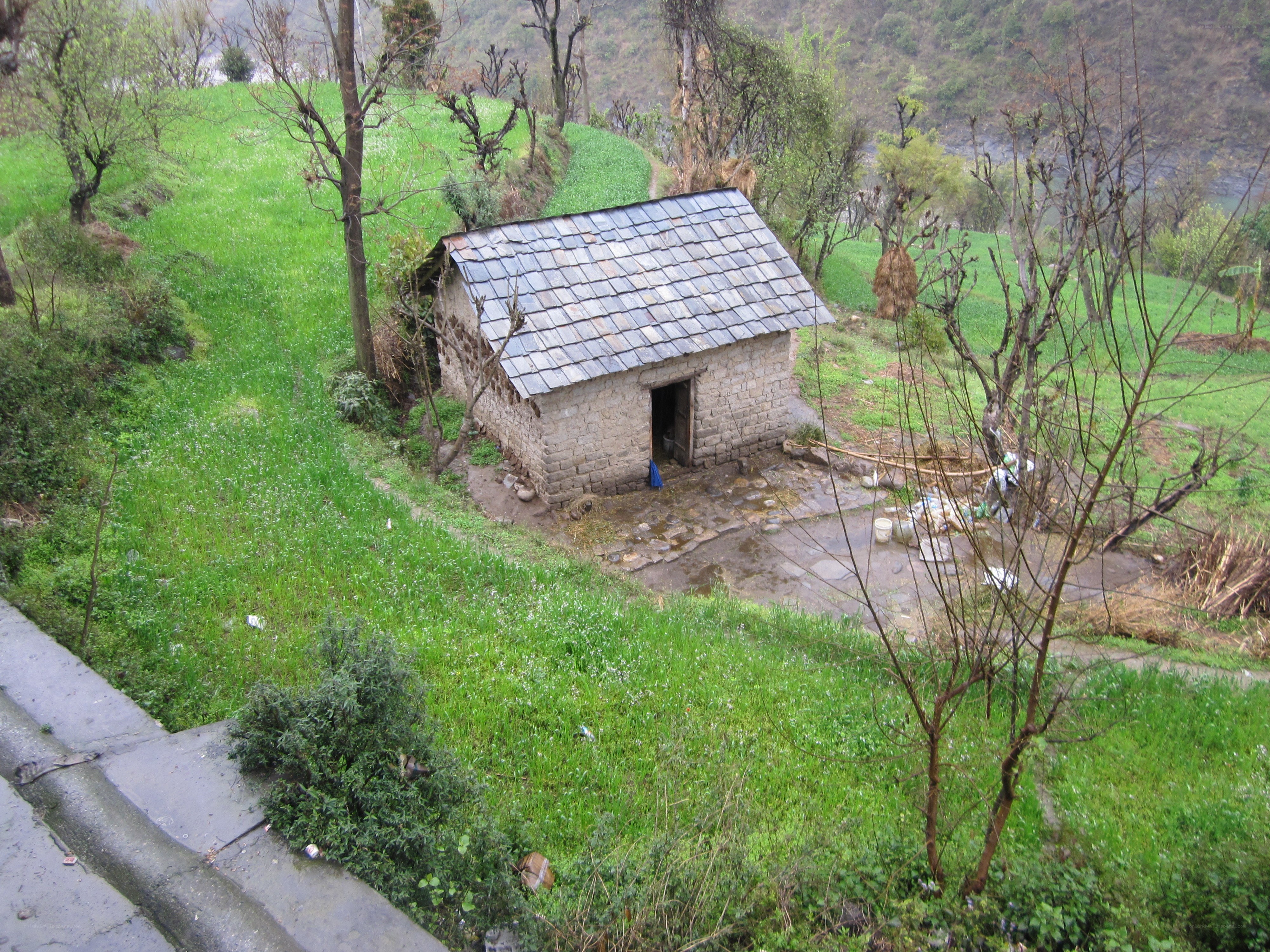 Stone hut on a green hillside