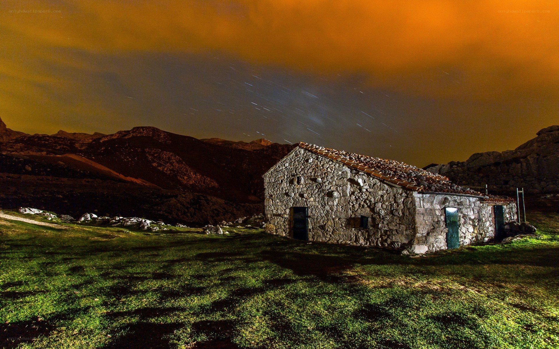Stone hut under starry sky